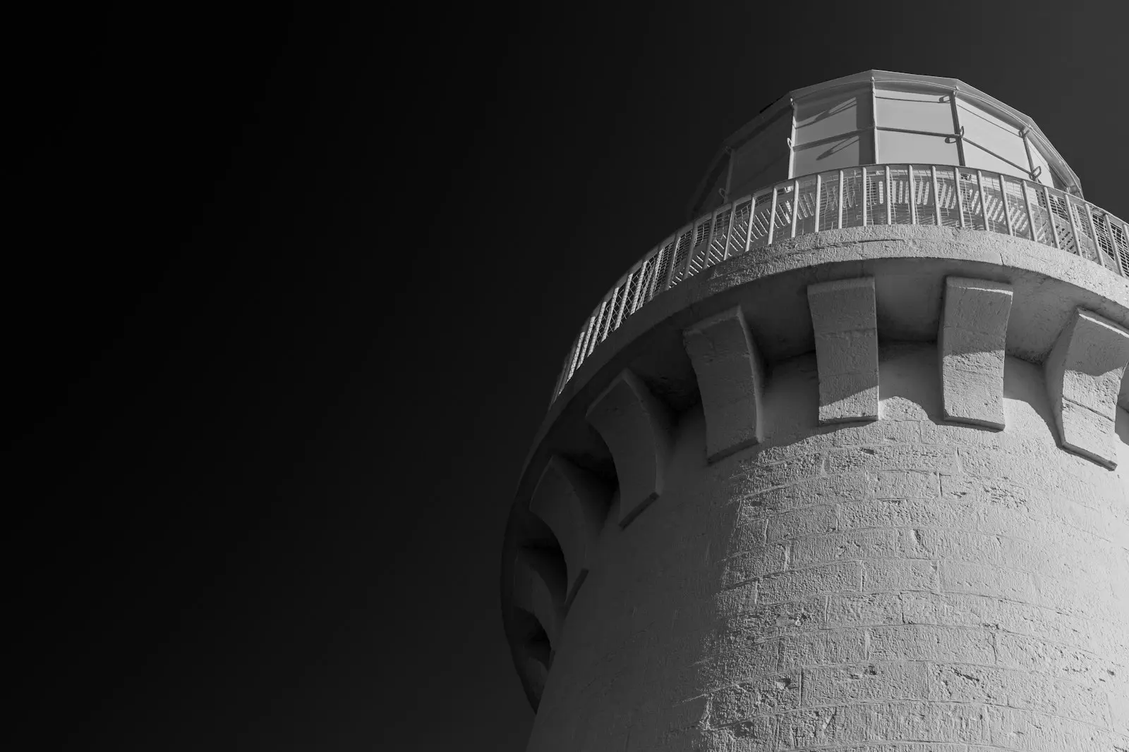 Lighthouse in grayscale against a plain sky
